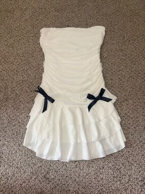 Strapless White Ruffled Mini Dress with Black Bow Details